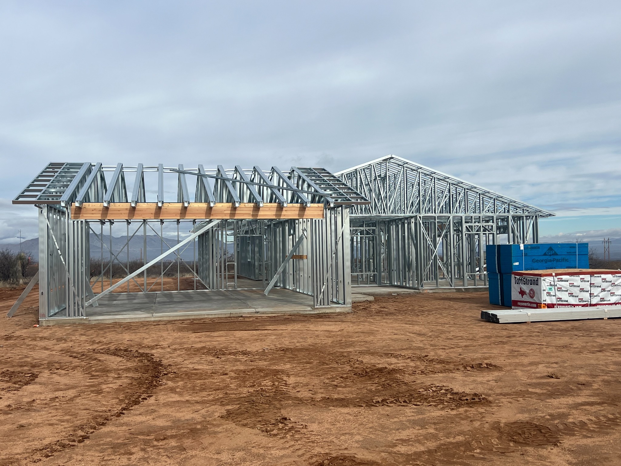 A cold-formed steel residential frame with roof trusses installed.