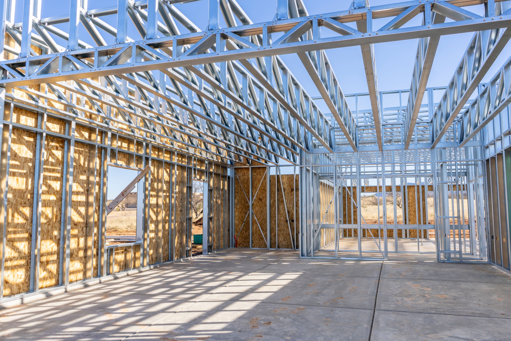 Interior of a cold-formed steel home showing roof trusses and wall framing.